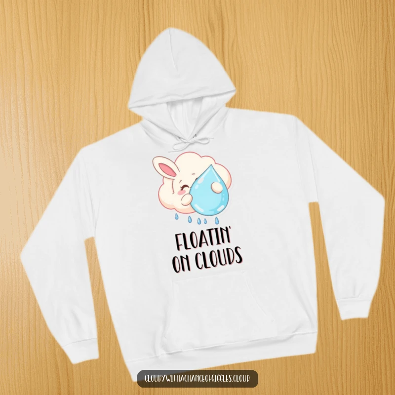 Funny hoodie featuring a smiling bunny-shaped cloud lazily floating and holding a large raindrop, offering warmth and a dose of adorable, gentle humor.