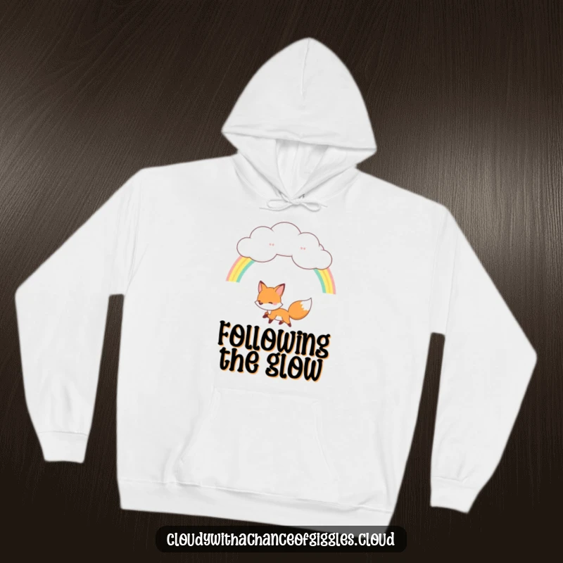 Funny fox hoodie, a joyful fox chasing a rainbow from a fluffy cloud, comfortable and magical outerwear.