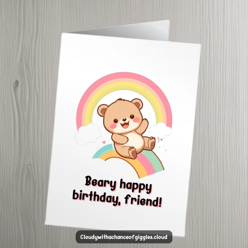 Funny Free Printable Birthday Card: A playful bear cub grins widely while sliding down a vibrant rainbow, spreading birthday cheer.