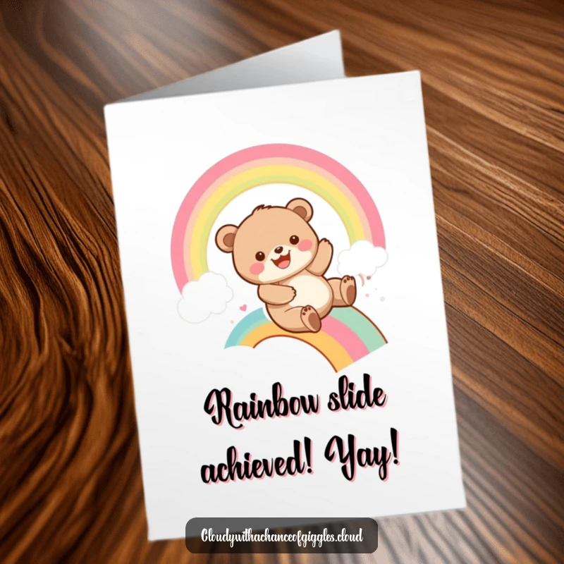 Funny Free Printable Congratulations Card: A grinning bear cub slides joyfully down a rainbow, celebrating achievements with infectious enthusiasm.